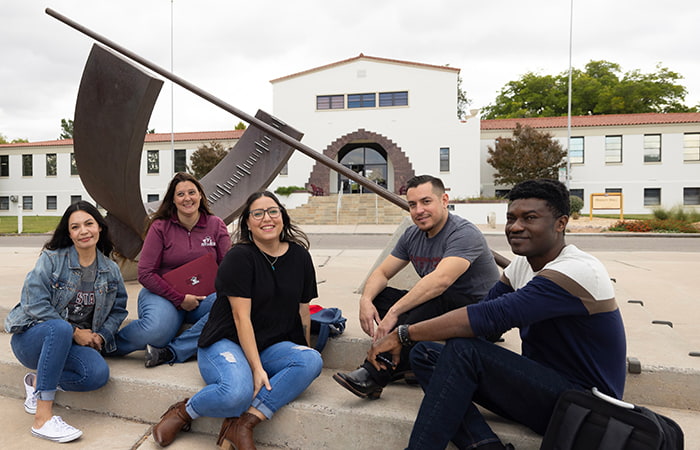 A group of NMSU students sitting posing for the camera
