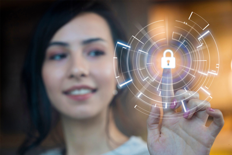 A woman touches her index finger to a digital lock icon.