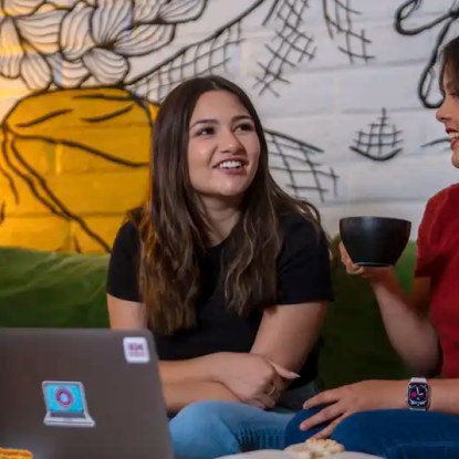 Two New Mexico State University students chatting in a coffeehouse — NMSU Global Campus