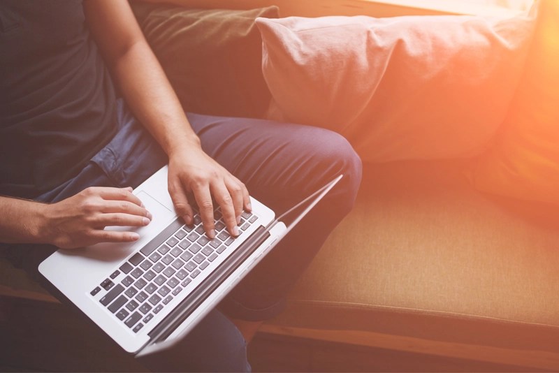 a person typing on a laptop