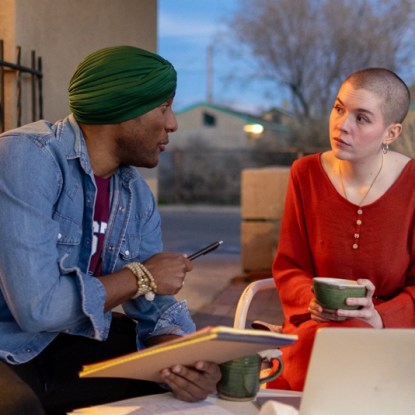 a man and a woman sitting at a table a man and a woman sit at a table having an intellectual discussion