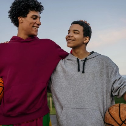 a couple of young men holding basketballs