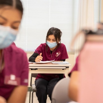 Nursing school students wearing masks in a classroom