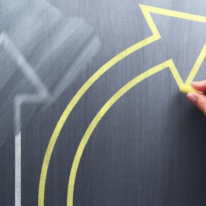 Decorative image of a hand drawing arrows on a chalkboard