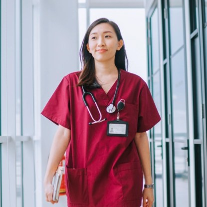 A woman in medical scrubs with a healthcare microcredential from NMSU Global Campus