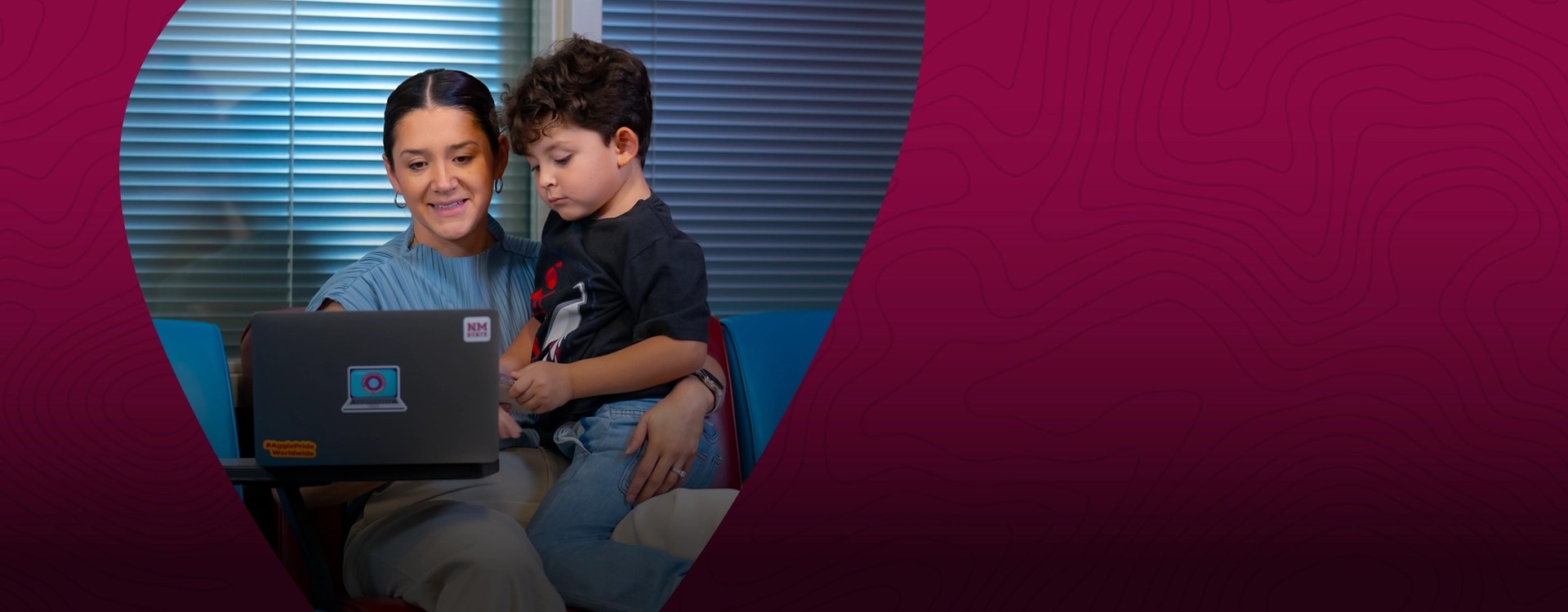 A working mom with a child in her lap applies for New Mexico Opportunity Scholarship at NMSU Global Campus