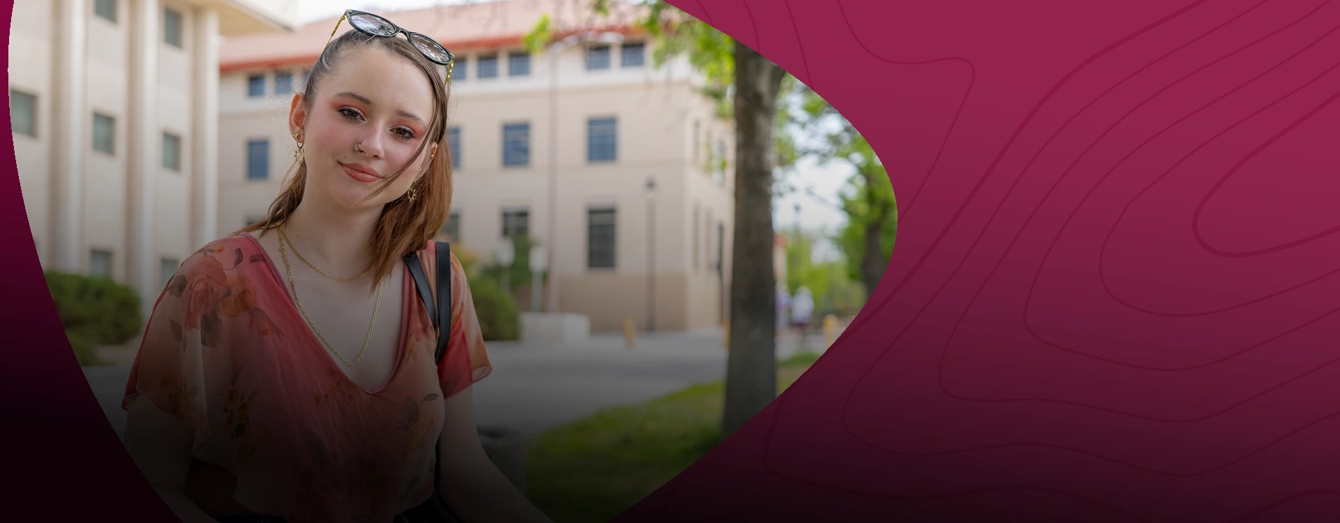 Smiling female student poses in front of school building — Apply to New Mexico State University Global Campus