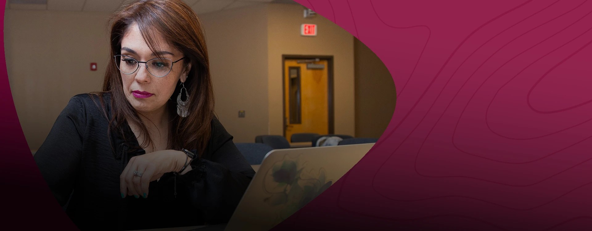 A business professional works at her desk — NMSU Global Campus