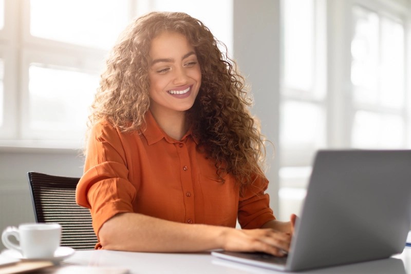 An MBA student using her laptop computer — online MBA programs at NMSU Global Campus