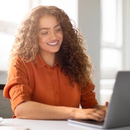 An MBA student using her laptop computer — online MBA programs at NMSU Global Campus