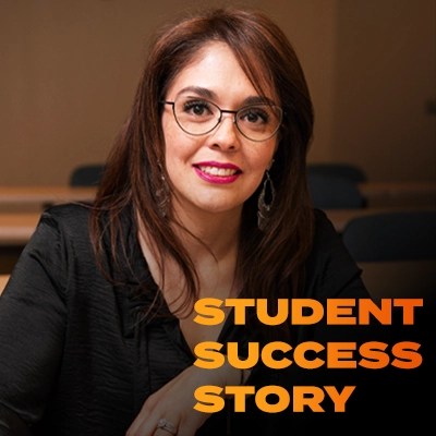 A woman in glasses poses in business attire — NMSU Global Campus