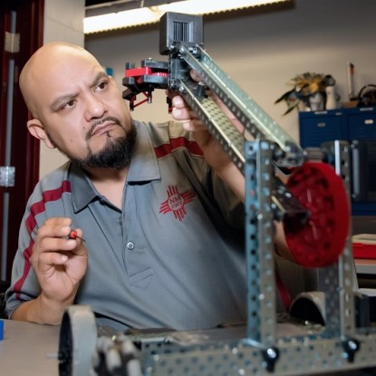 An engineer uses tools in a workshop