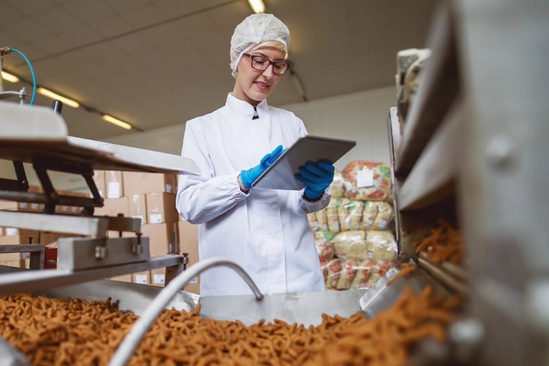 A food scientist takes notes on a tablet computer