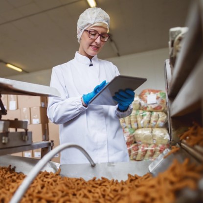 A food scientist takes notes on a tablet computer