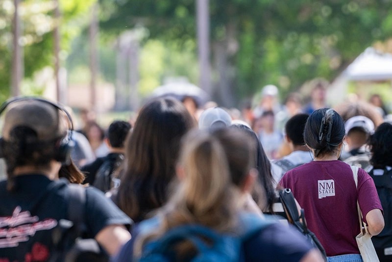 New Mexico State University students walking outdoors on campus