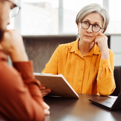 A therapist listens to her client with a look of concern