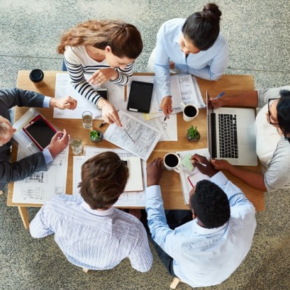 An aerial shot of a group of professionals working in a coffee shop