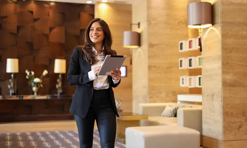 A hospitality manager walking through a hotel lobby