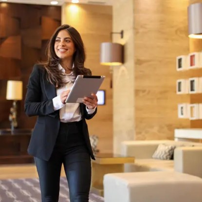 A hospitality manager walking through a hotel lobby