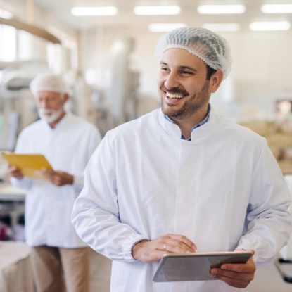 A food scientist takes notes in a test kitchen