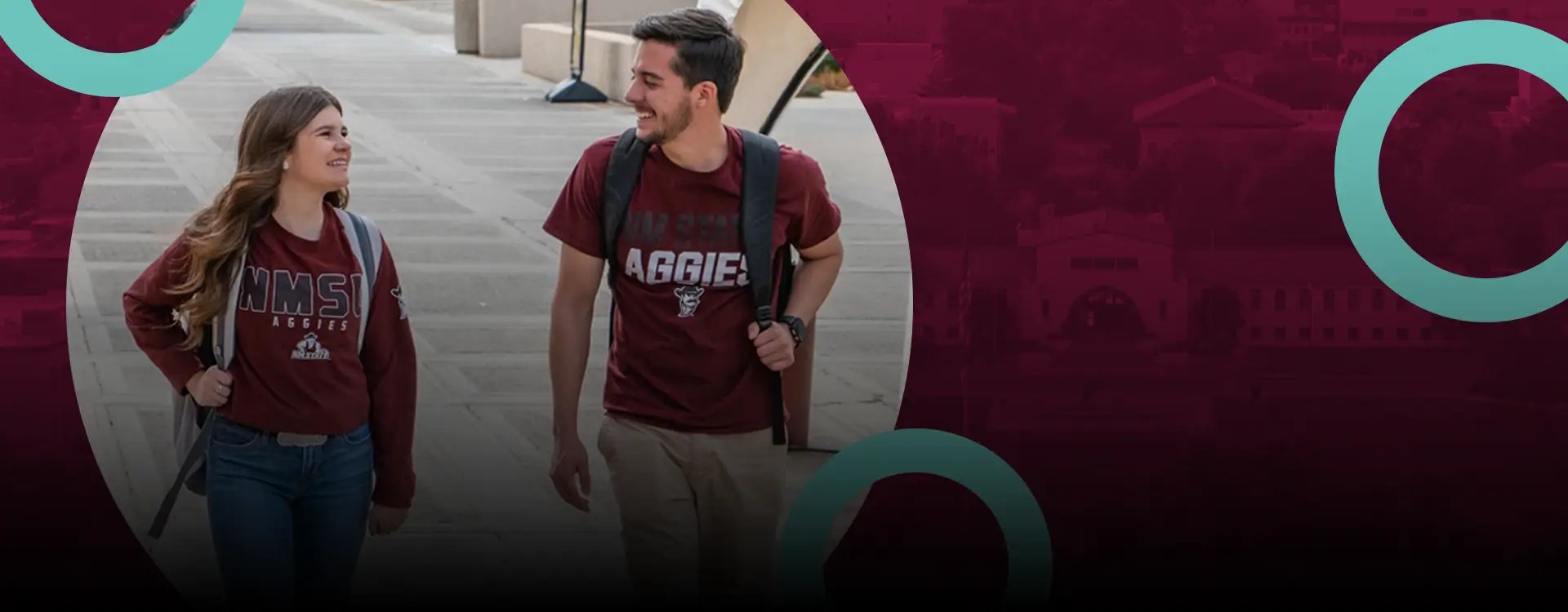 Two college students in NMSU Aggies T-shirts walking and smiling