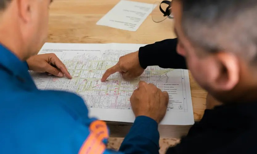 Two engineers examining technical documentation