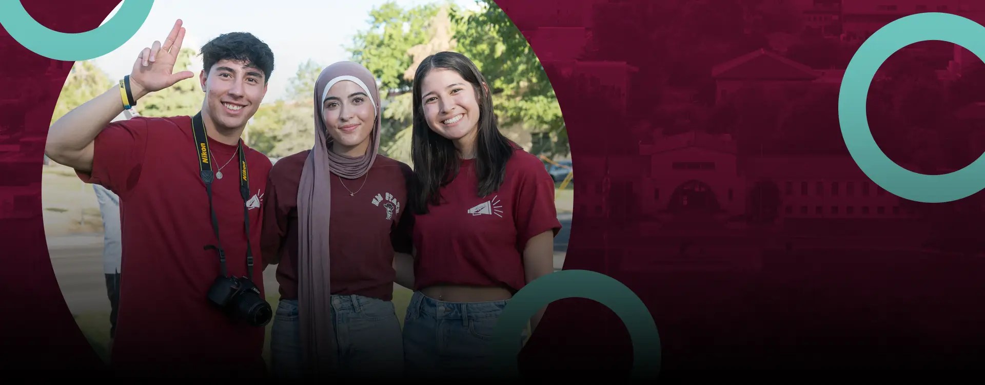 Three college students pose in New Mexico State University T-shirts