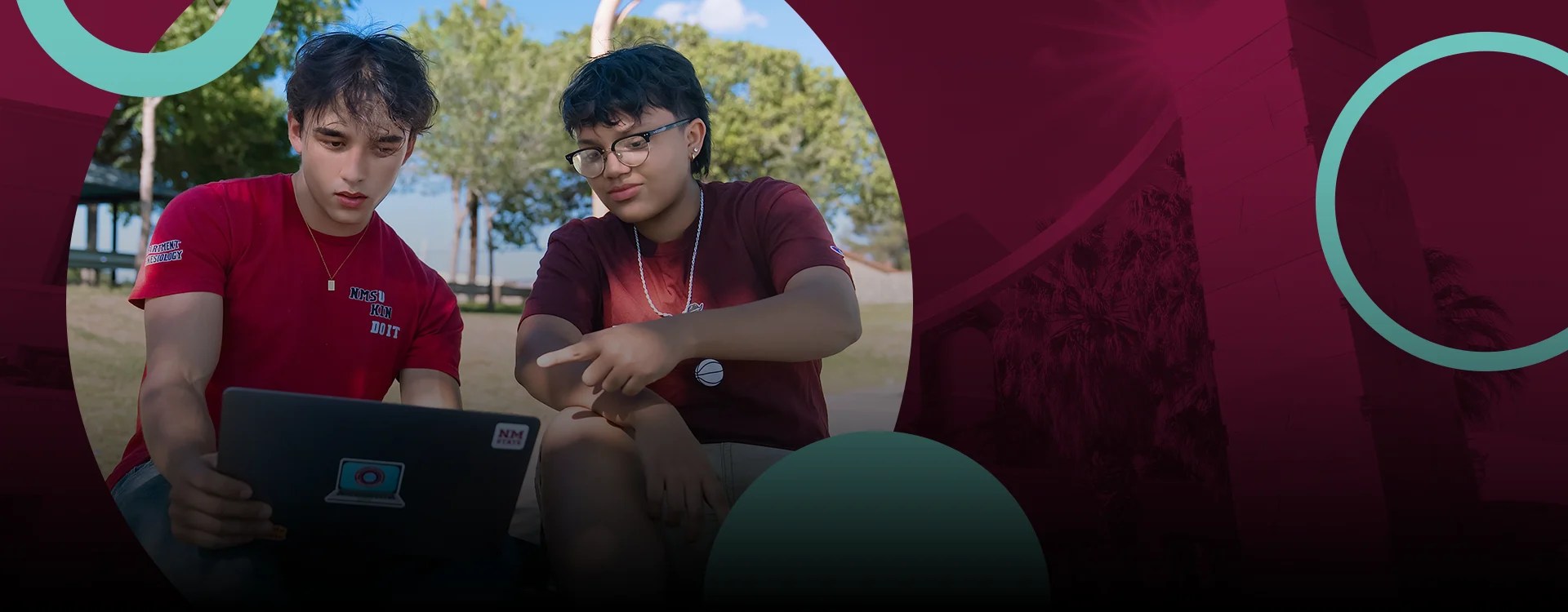 Two NMSU students working on a laptop computer together outdoors