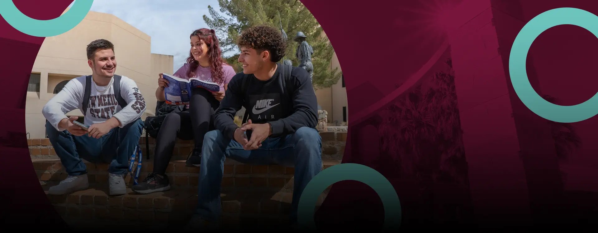 Three college students sitting outdoors on the New Mexico State University campus in Las Cruces
